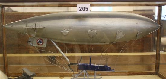 Painted model of a British Airship, SS36, with bi-plane, in glazed display case